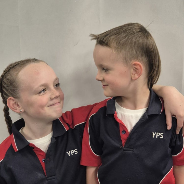 Sibling students smiling at each other